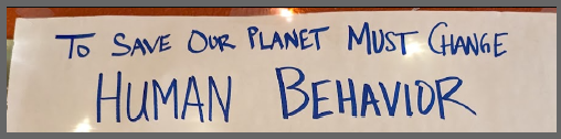 Whiteboard lettering: To save our planet must change human behavior.