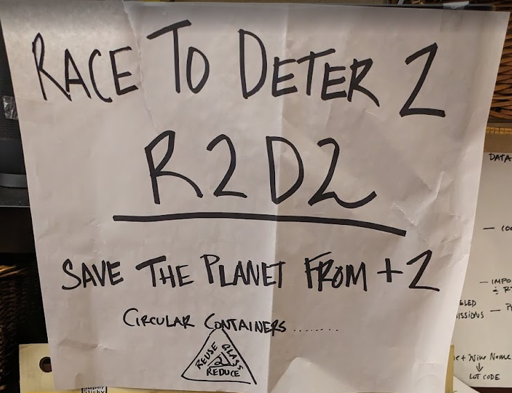 Hand-lettered poster: Race to Deter 2, R2D2, save the planet from +2, circular containers.